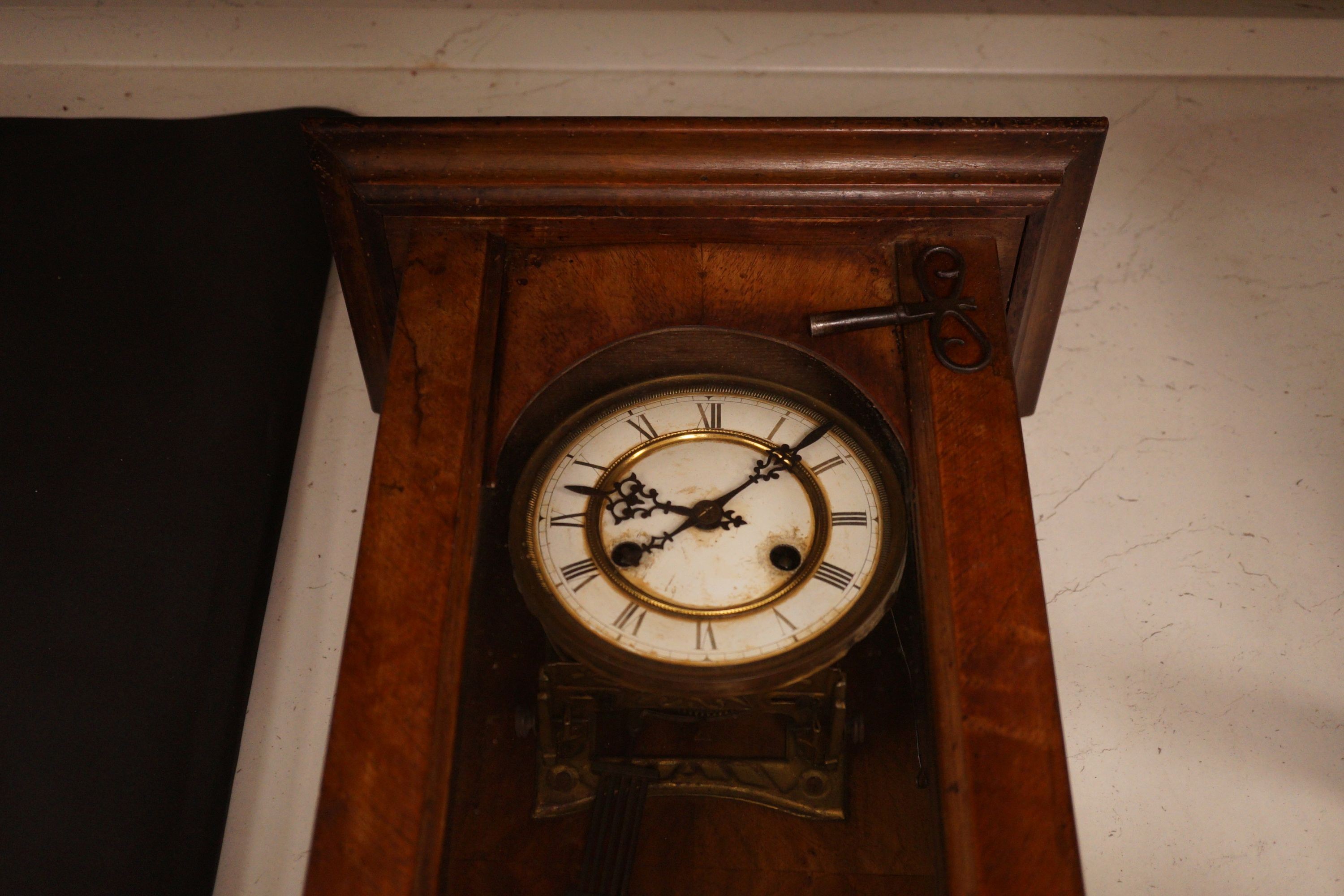 A small German wall clock with key, 58cm